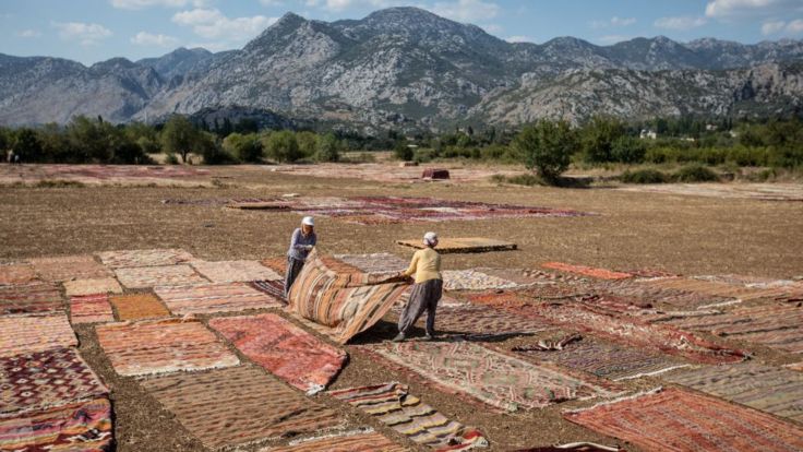 Turkish carpet-makers dry out their wares